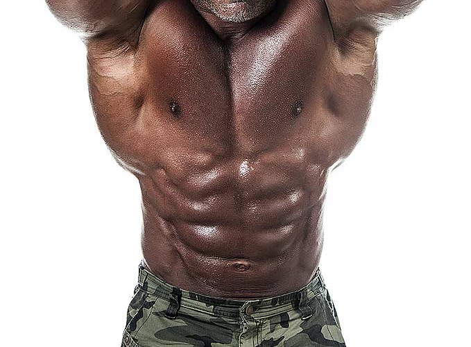 A bodybuilder with toned body showing his huge abs