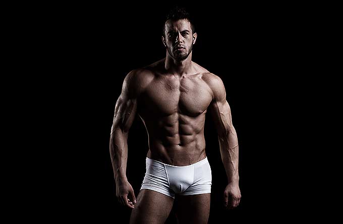 A muscular man in white briefs